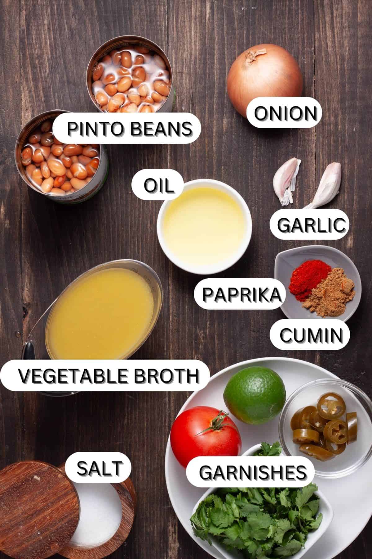 Ingredients for vegan refried beans on a dark table.