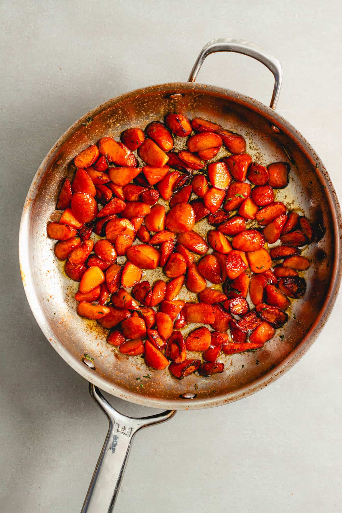 Sauteed spiced carrots in a large skillet.