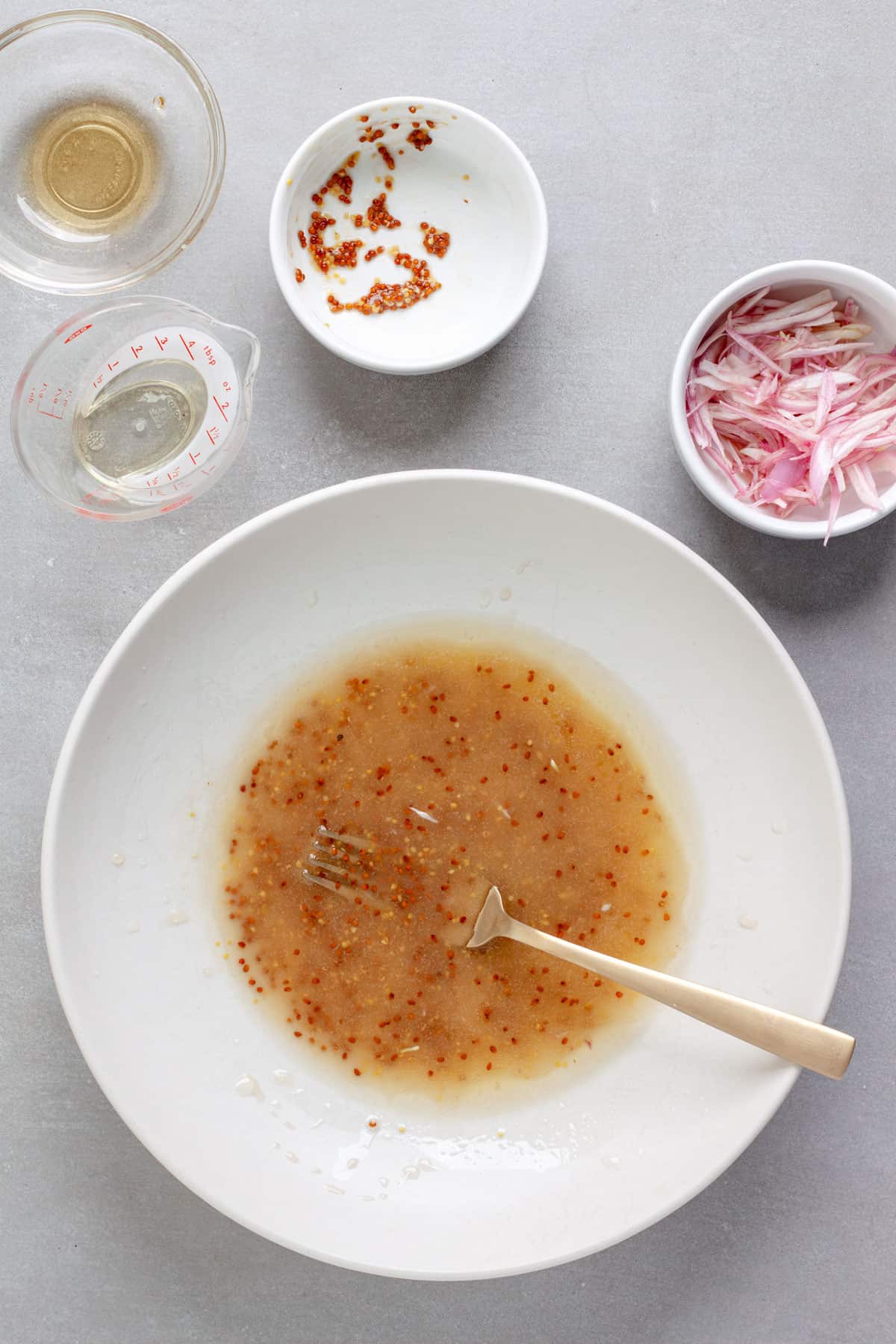 A white balsamic vinaigrette whisked together in a medium bowl.