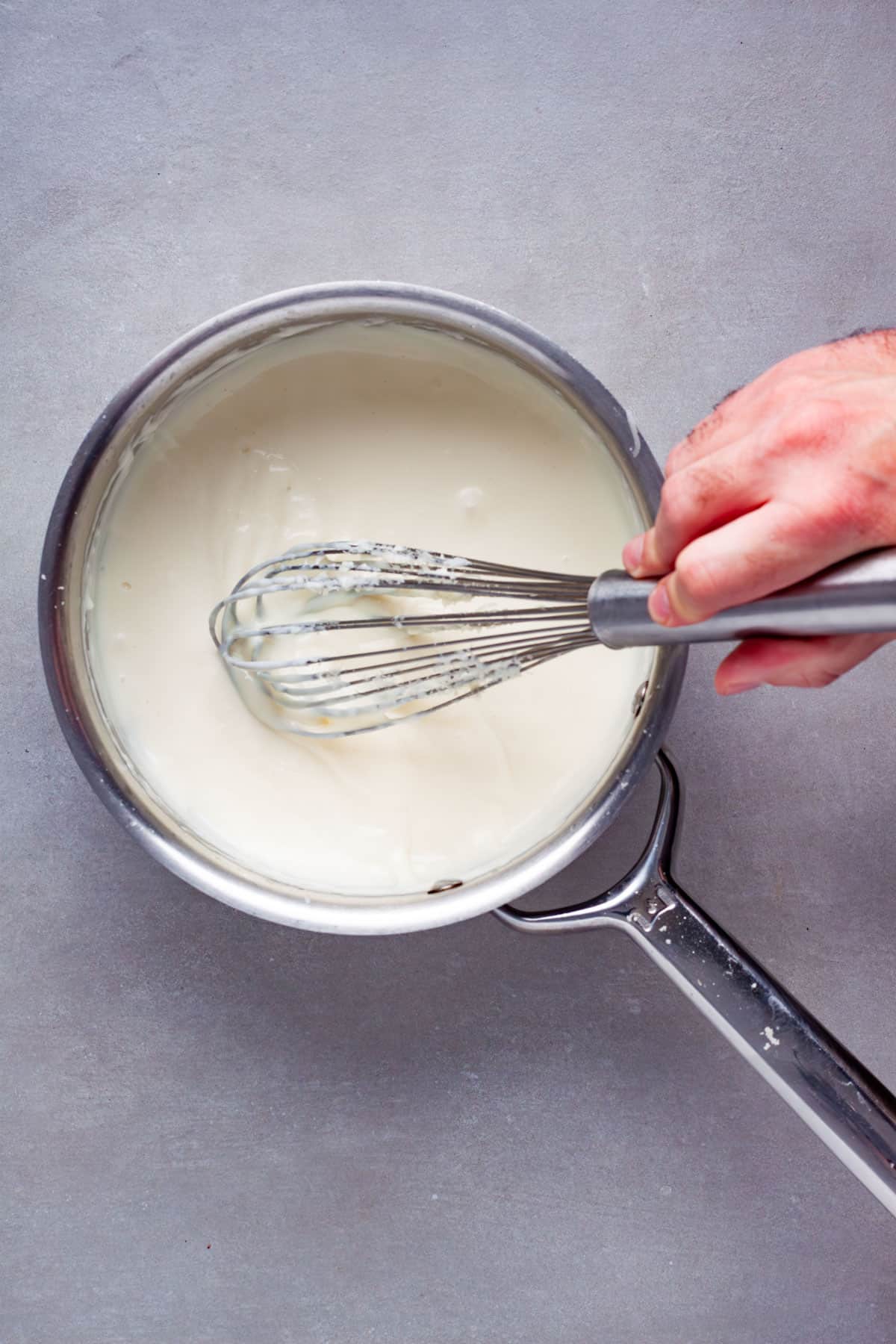 A bechamel getting cooked in a medium saucepan.