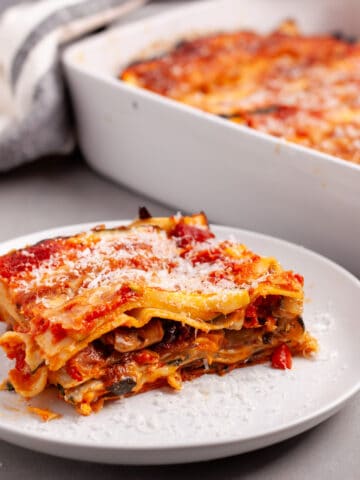A serving of vegetable lasagna on a white plate.
