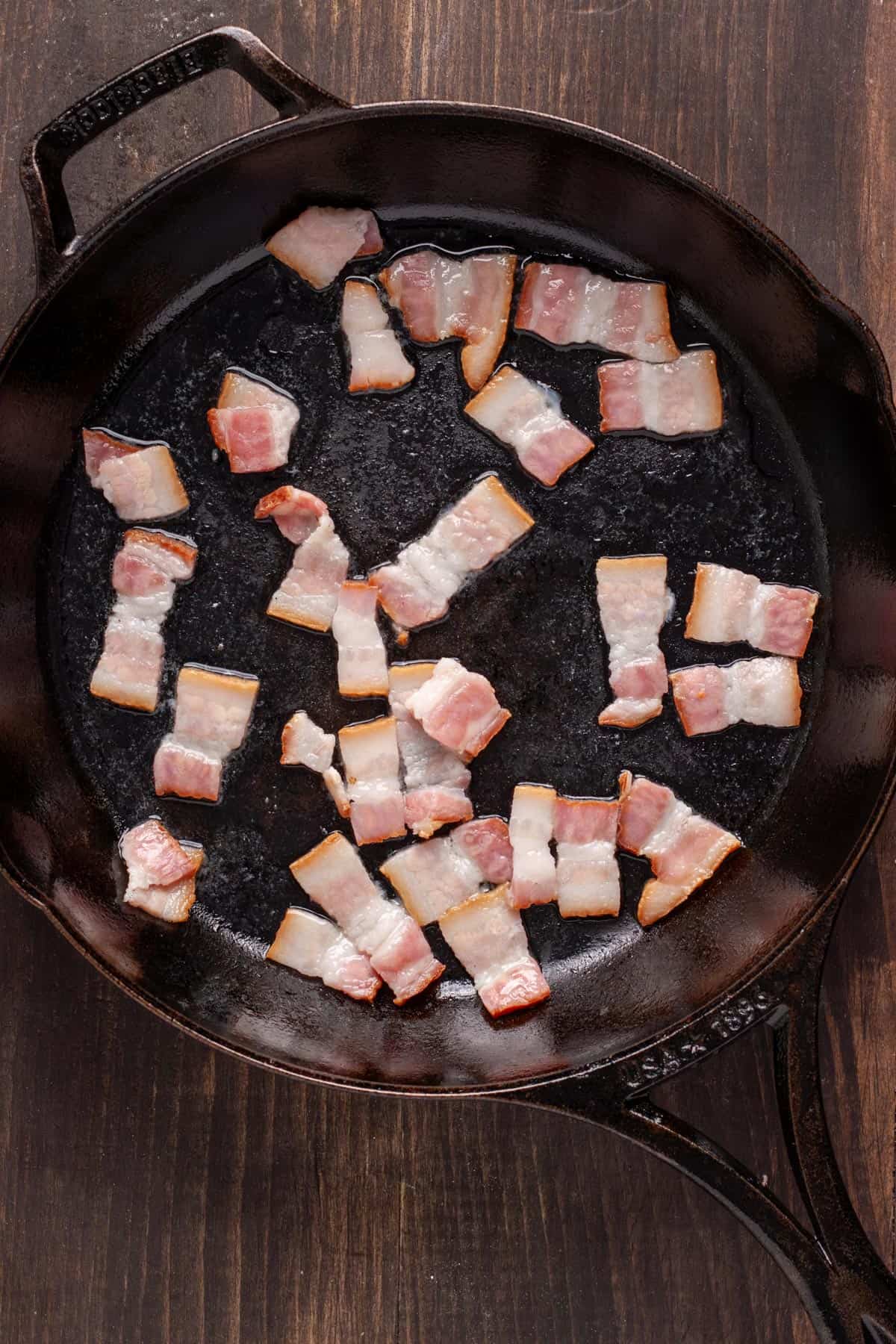 Chopped bacon in a cast iron skillet ready to get cooked.