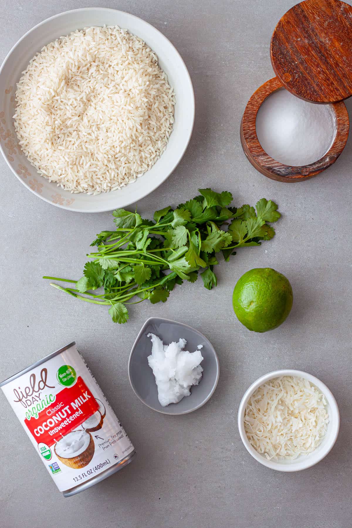 Ingredients for coconut cilantro rice on a gray table.