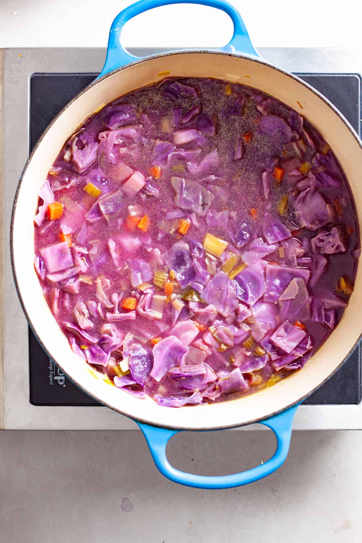 Red cabbage soup simmering in a large Dutch oven.