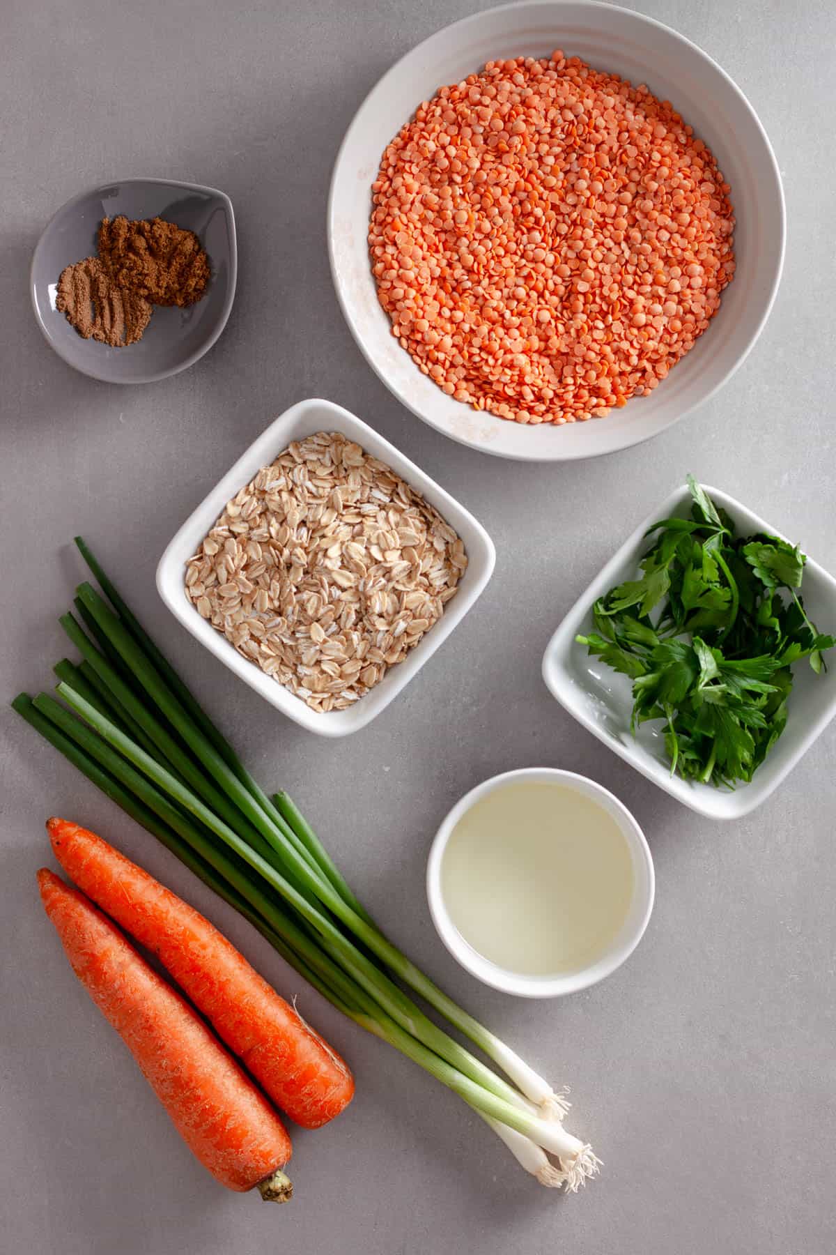 Ingredients for red lentil patties on a gray table.