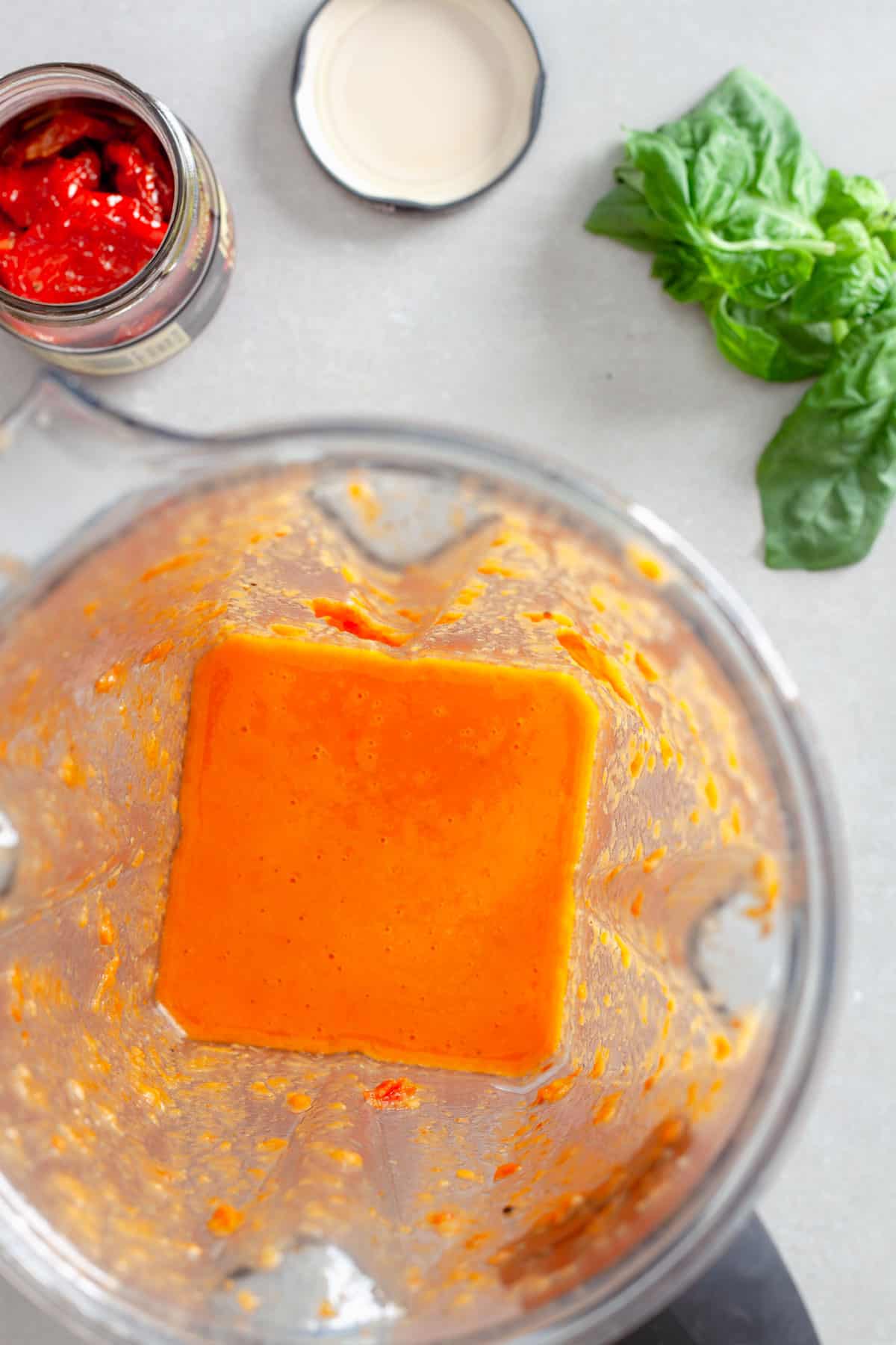 A blender with sun-dried vinaigrette just blended to a smooth consistency.