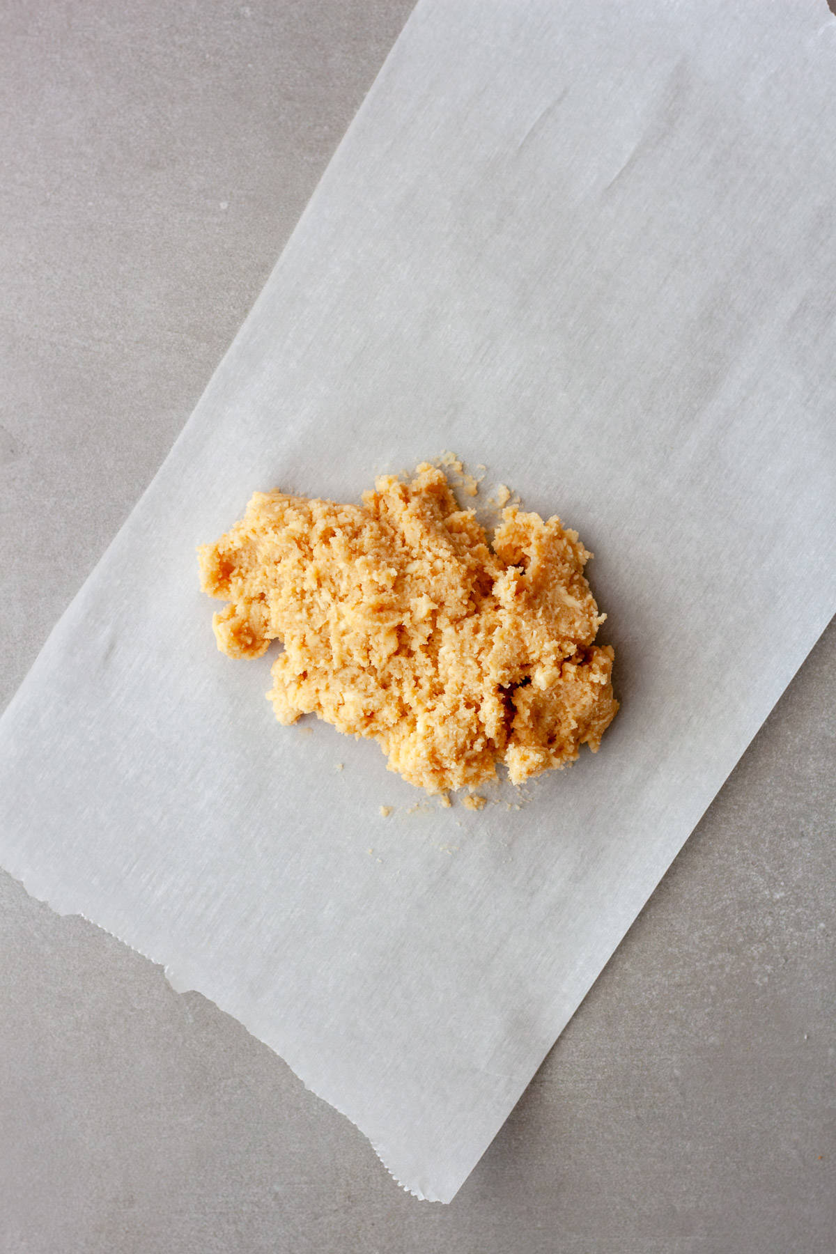 A pile of miso butter on a piece of white parchment paper.