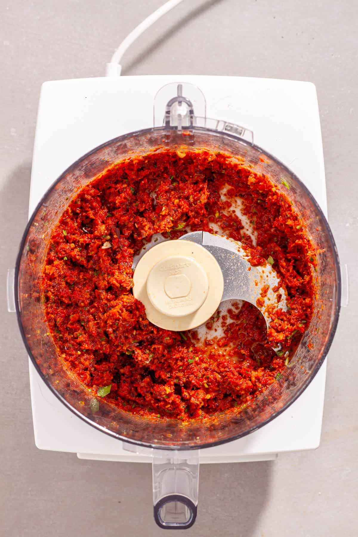 Homemade sun-dried tomato spread in a food processor blended to a paste.