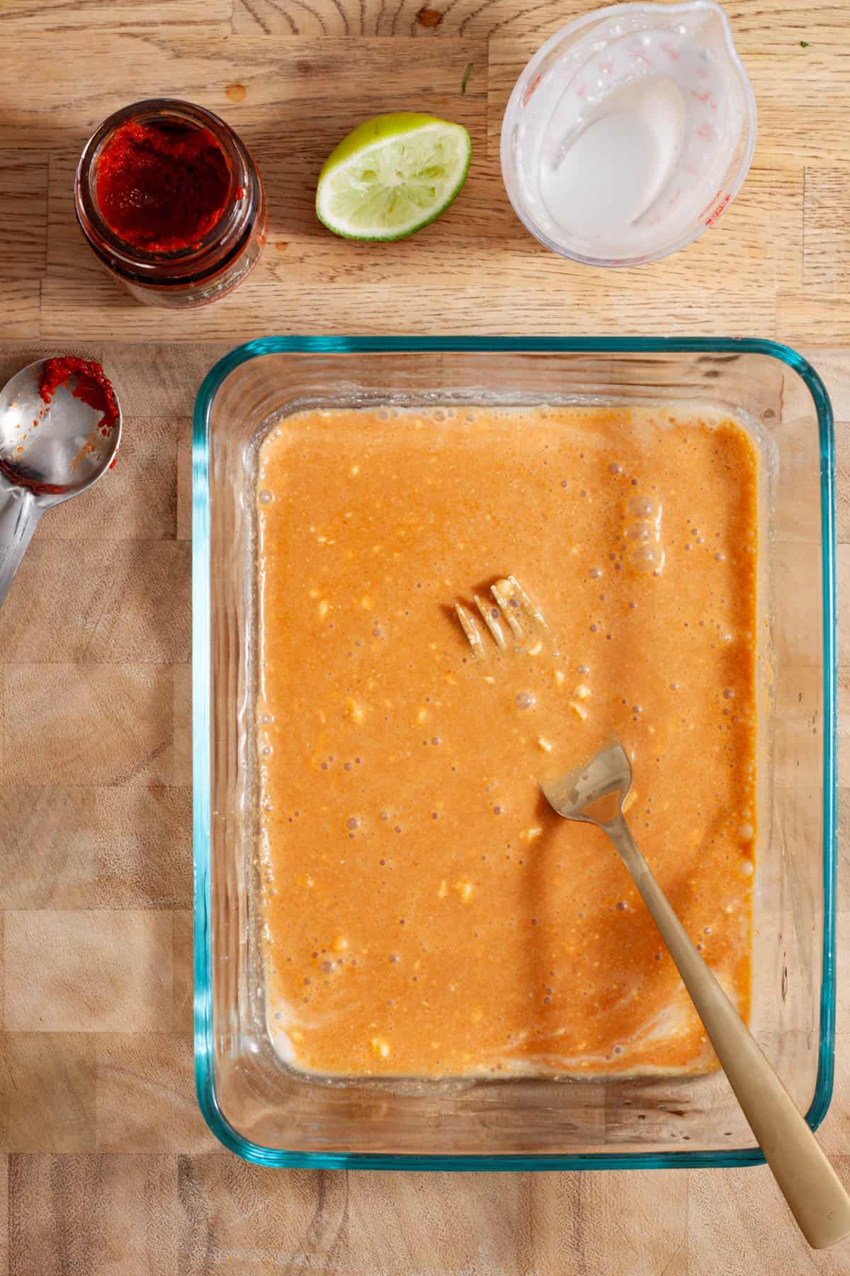 A marinade for tofu satay in a glass container.