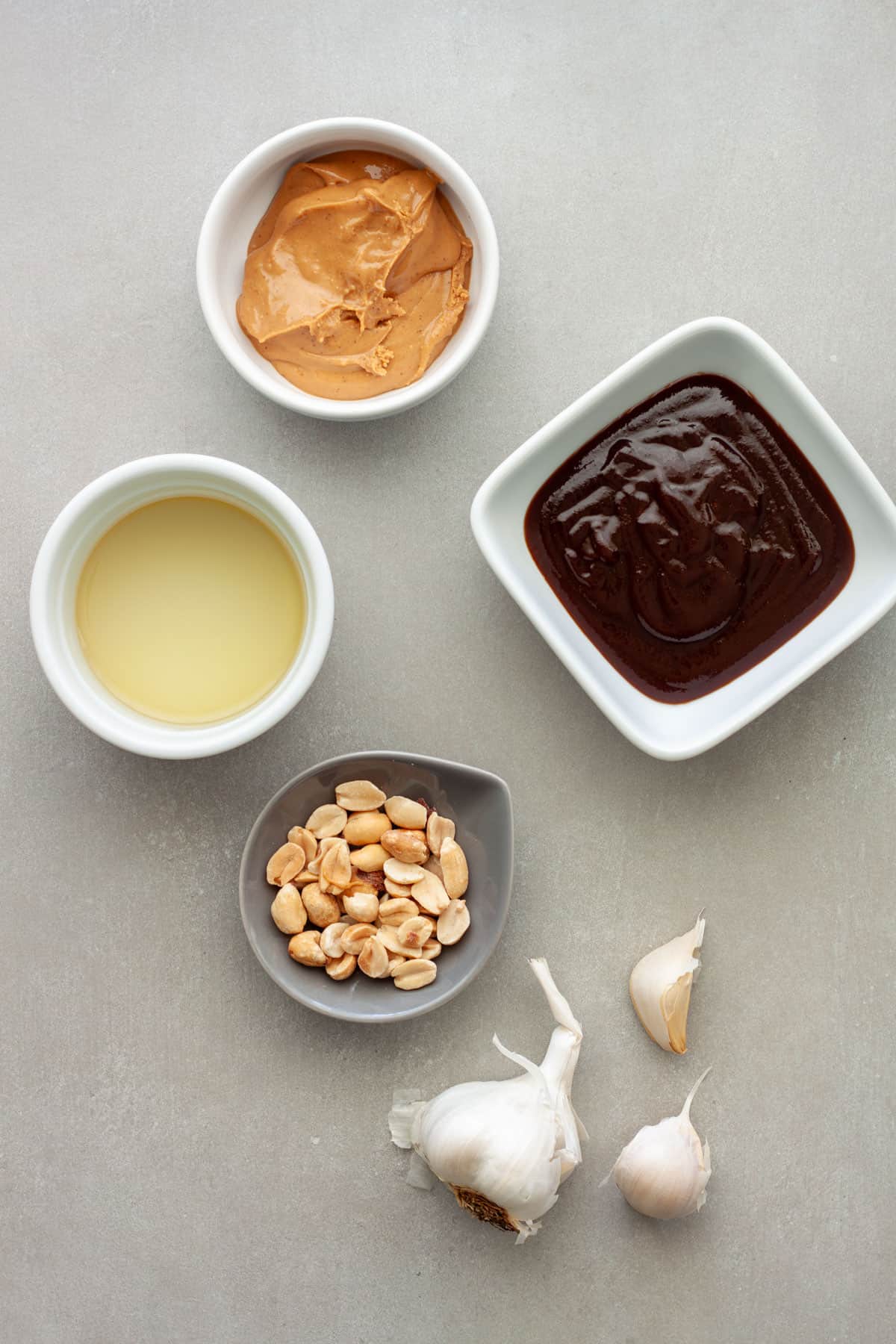 Ingredients for Vietnamese peanut sauce on a gray table.