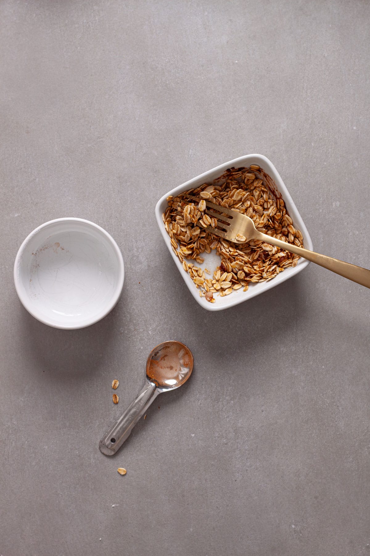 A crunchy oat topping for muffins getting stirred together in a small bowl.