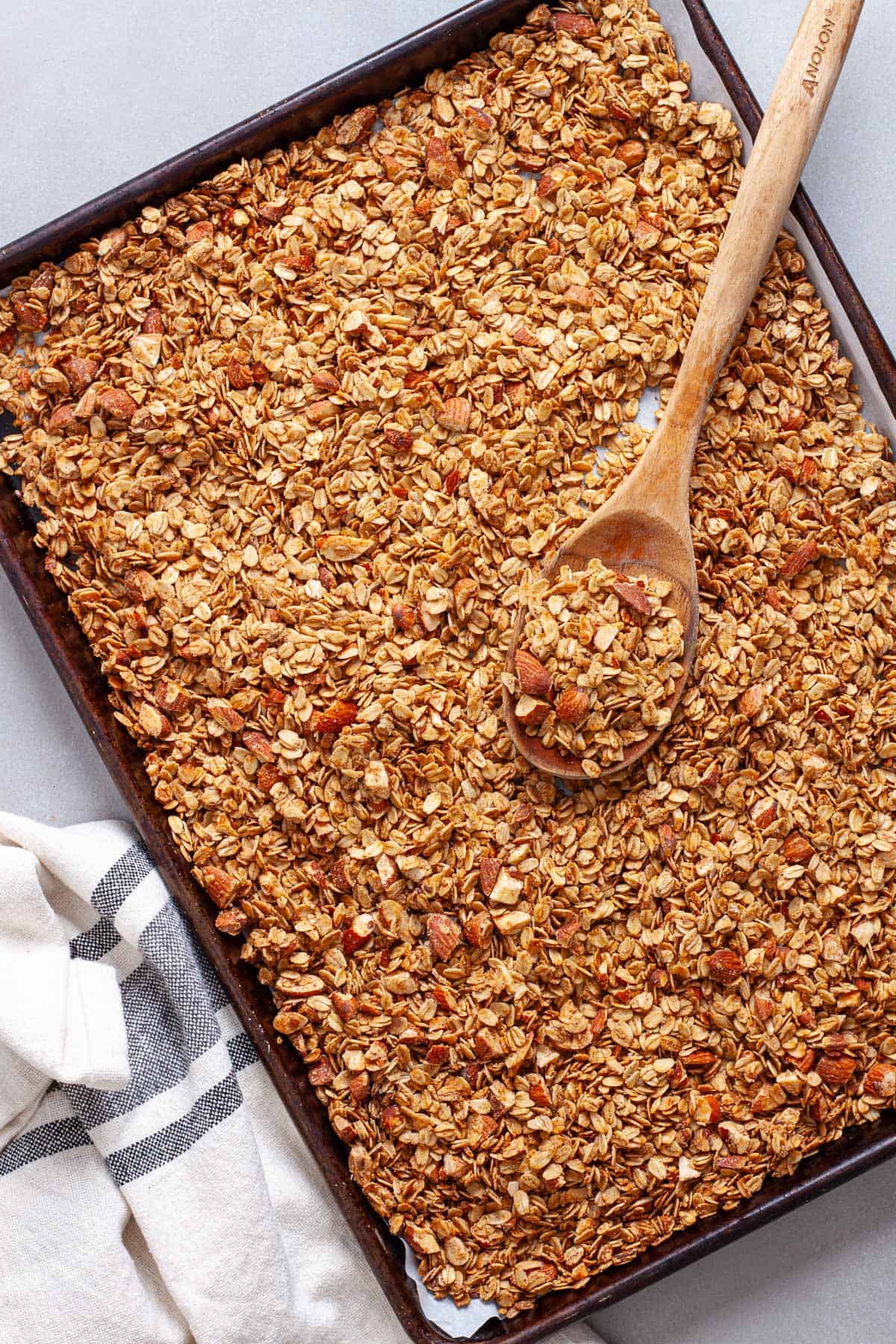 Homemade granola on a parchment lined baking sheet.