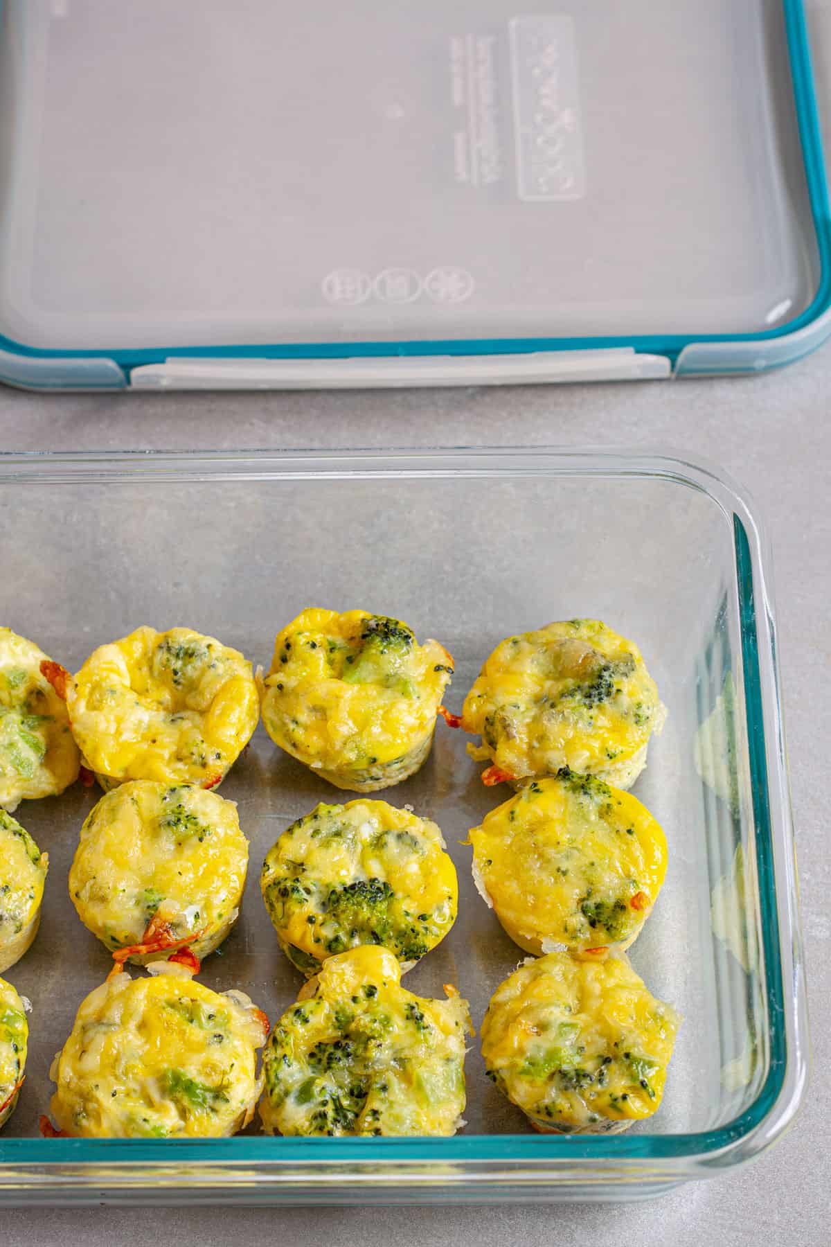 A glass storage container with min egg bites for meal prep.