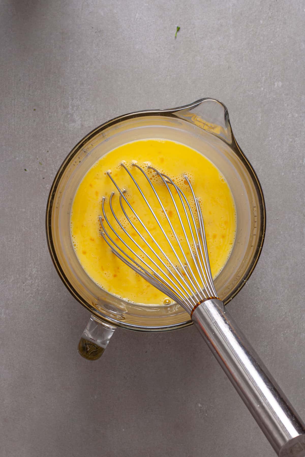Egg s and milk whisked together in a  large measuring cup.