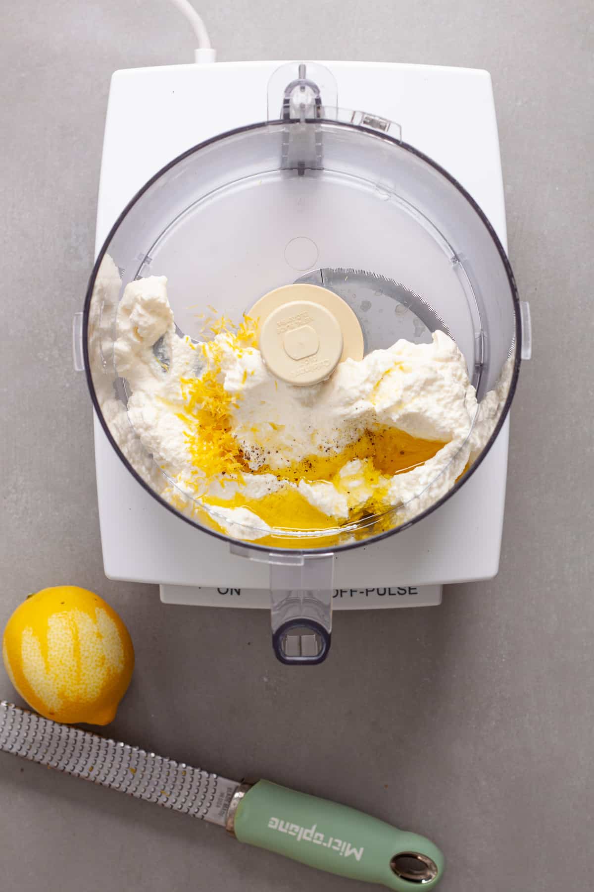 Ricotta cheese, lemon zest, salt, pepper and olive oil in a food processor.