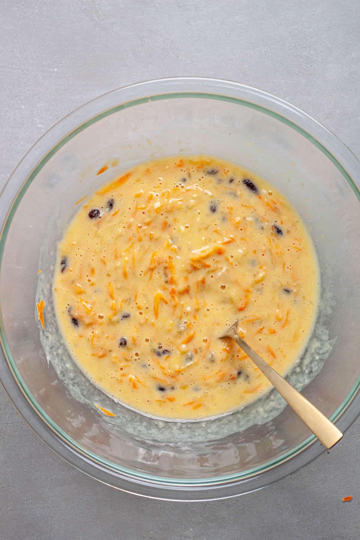 Wet ingredients for carrot muffins mixed together in a large bowl.