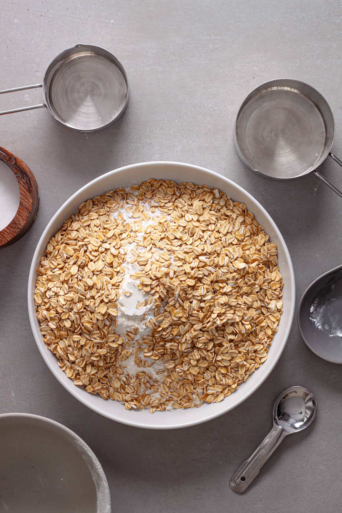 Dry ingredients for blackberry oat muffins on a mixing bowl.