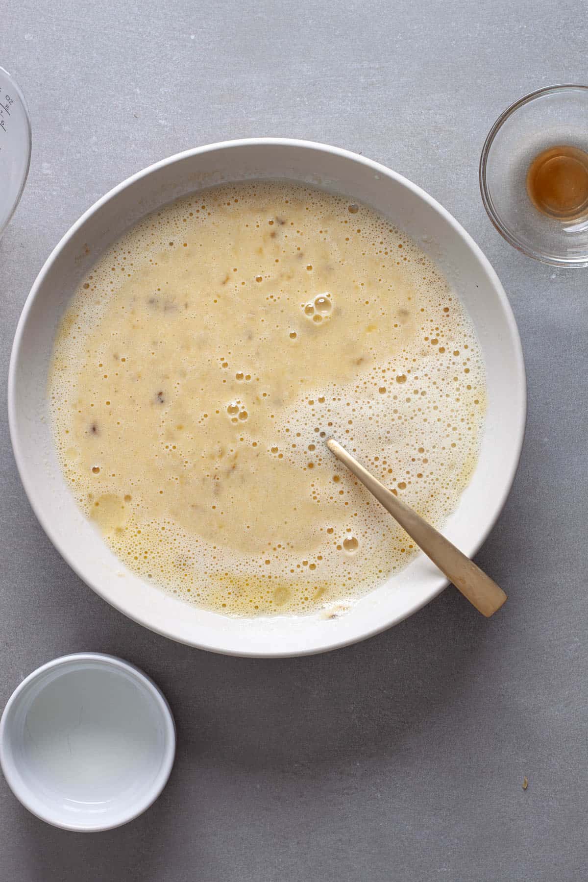 Wet ingredients for oat muffins in a medium bowl mixed together.