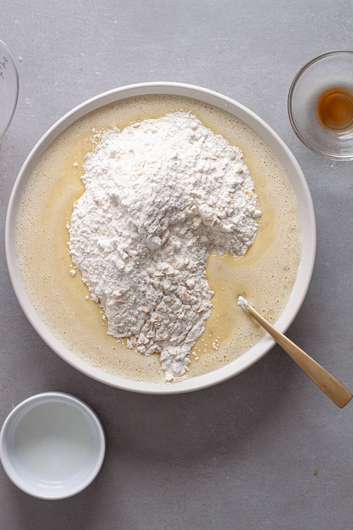 Dry ingredients added to the wet ingredients for homemade blackberry oat muffins.