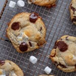 Chocolate chip marshmallow cookies cooling on a wire rack.