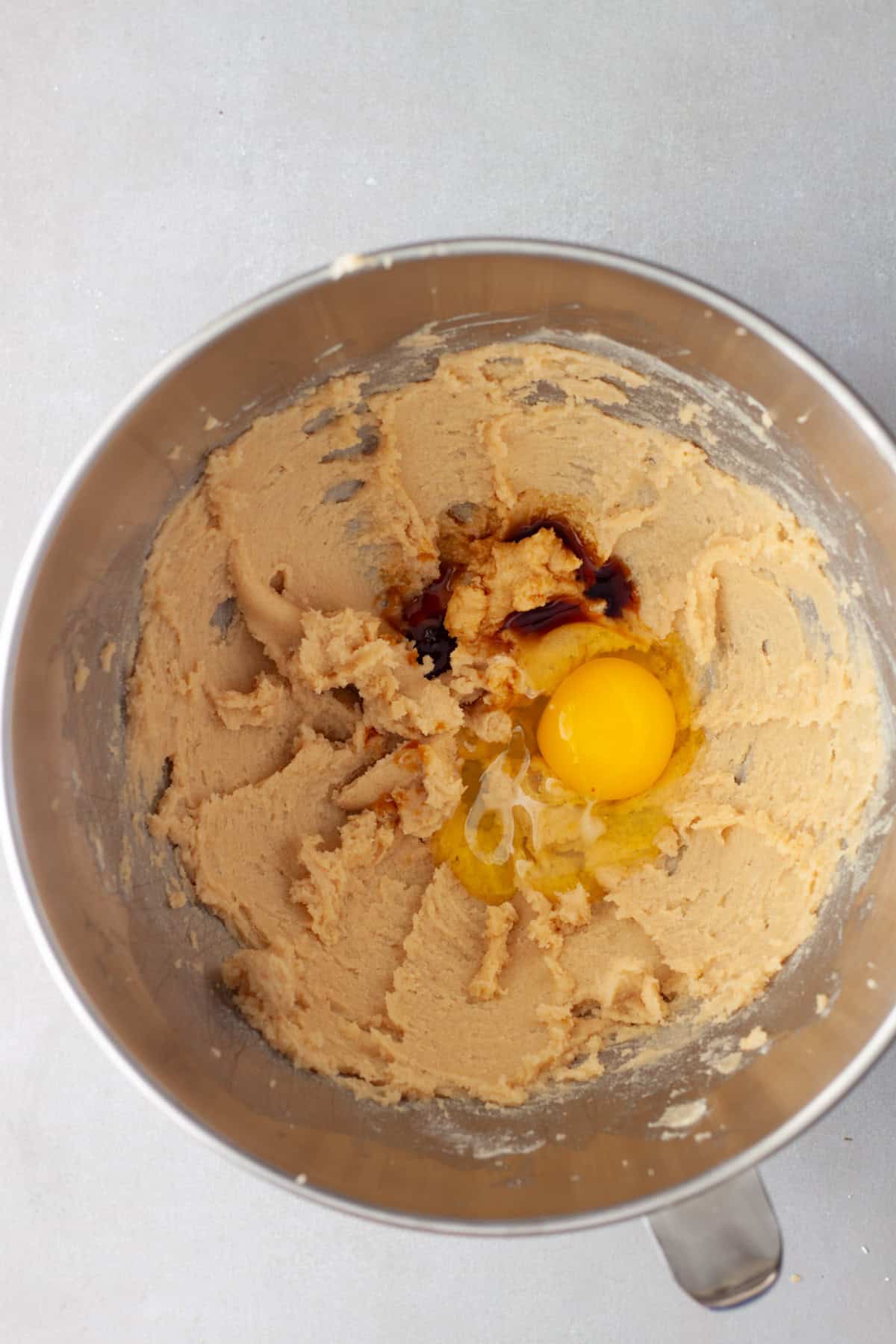 Whipped butter and sugar in a mixing bowl with an egg and vanilla added for a cookie base.