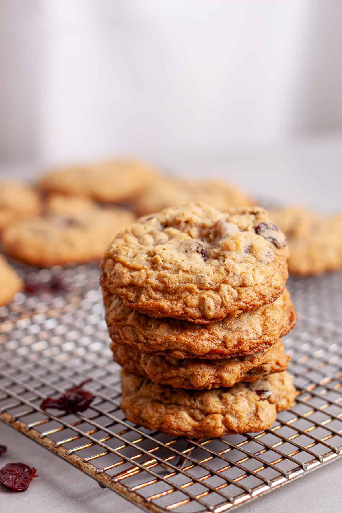 a stack of cherry oatmeal cookies on a wire rack.