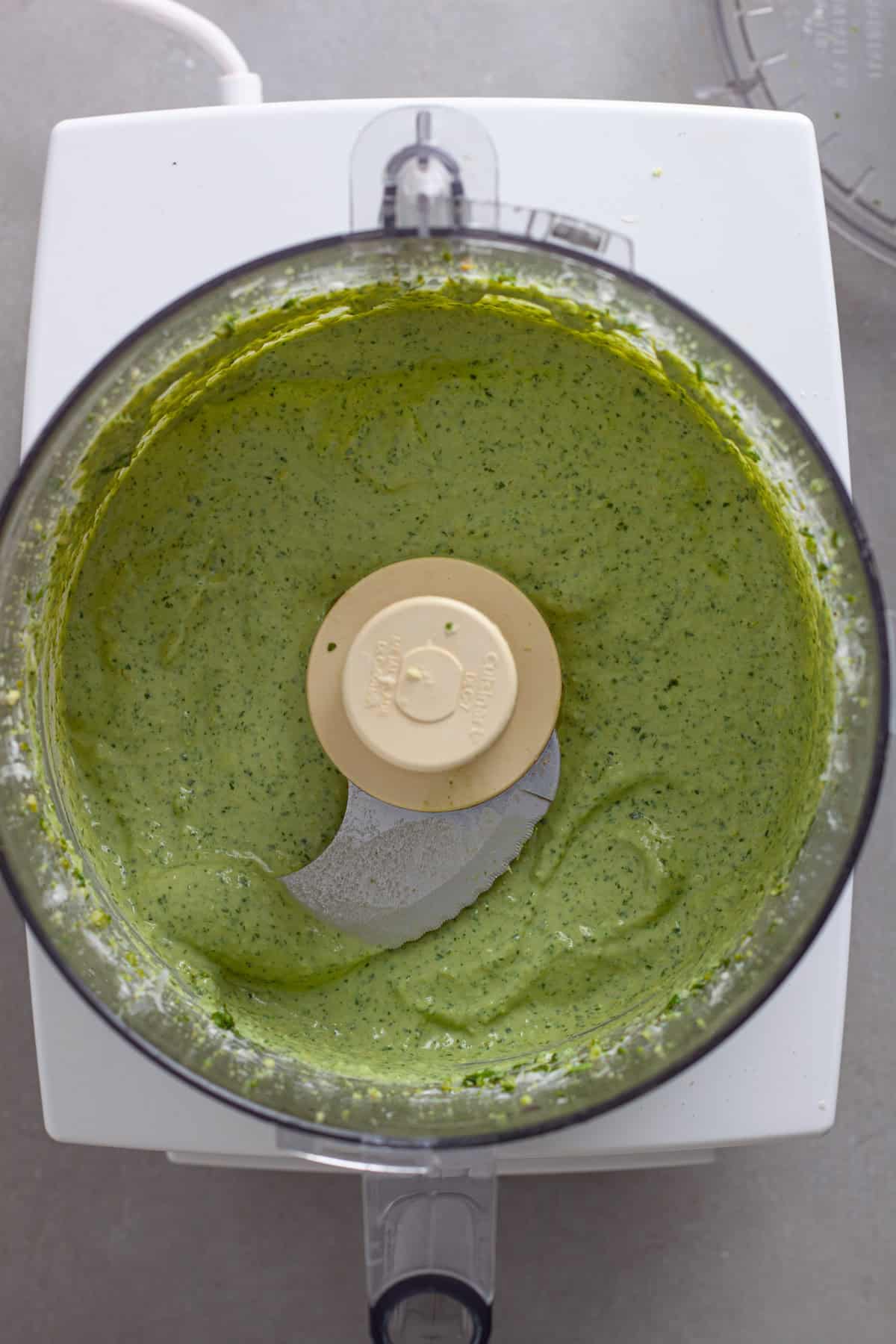Ricotta pesto sauce in a food processor freshly blended.