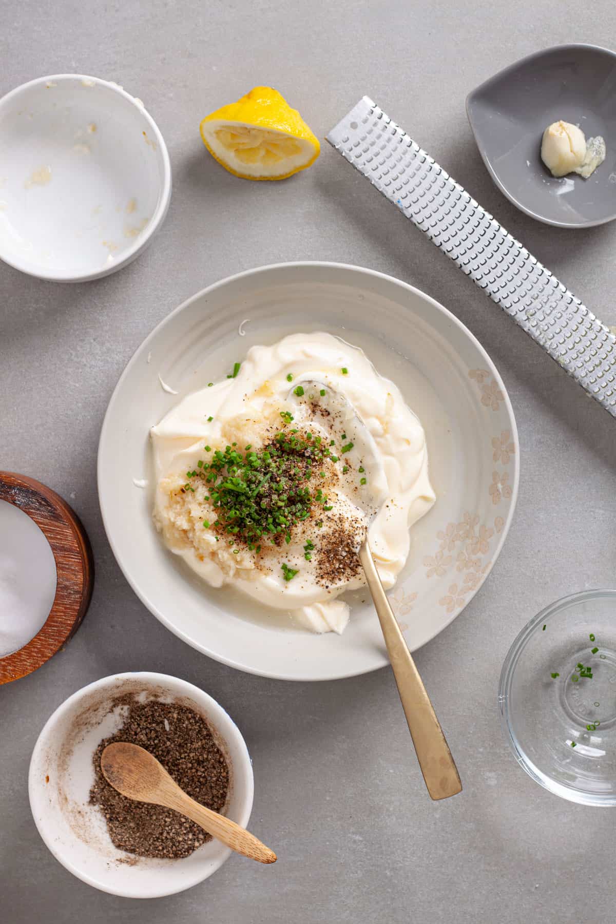 A small mixing bowl with ingredients for a horseradish aioli.