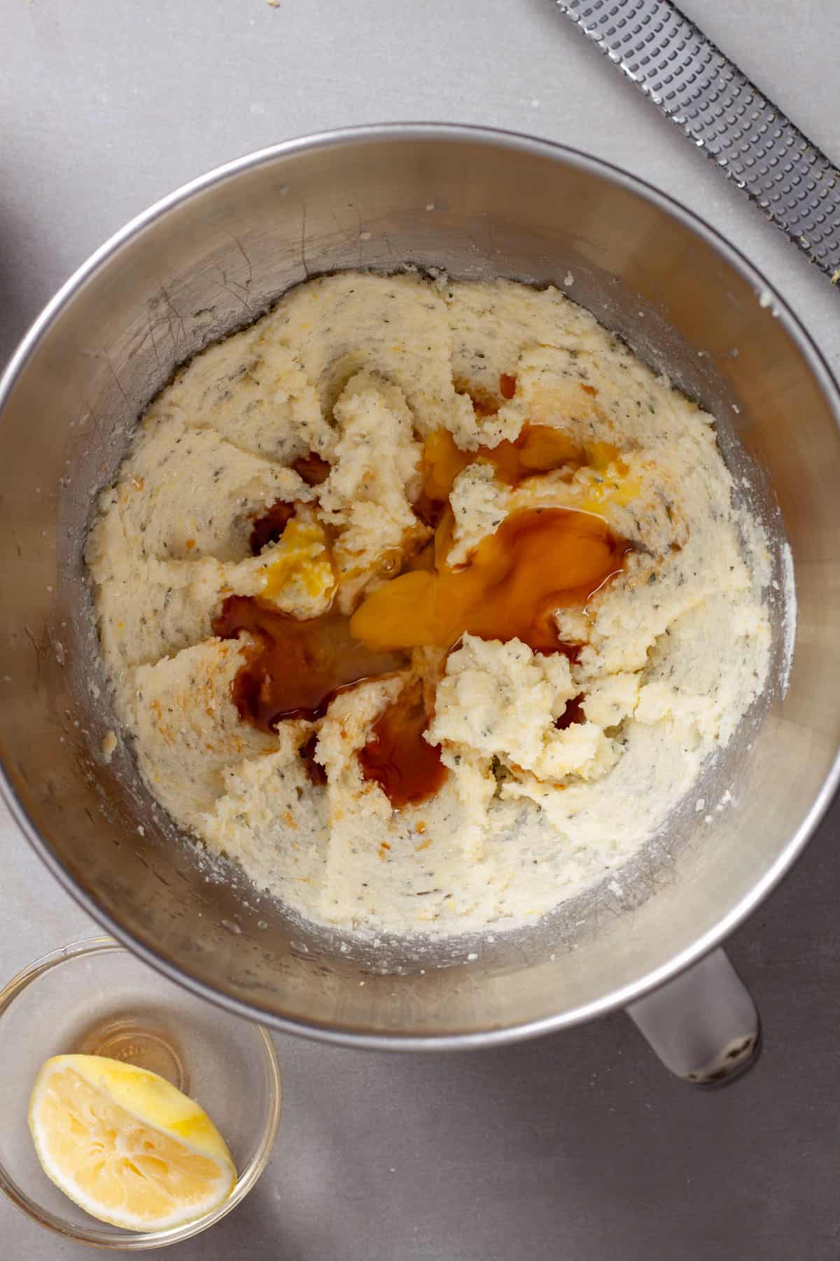 Lemon and white chocolate chip cookies getting assembled in a metal bowl.