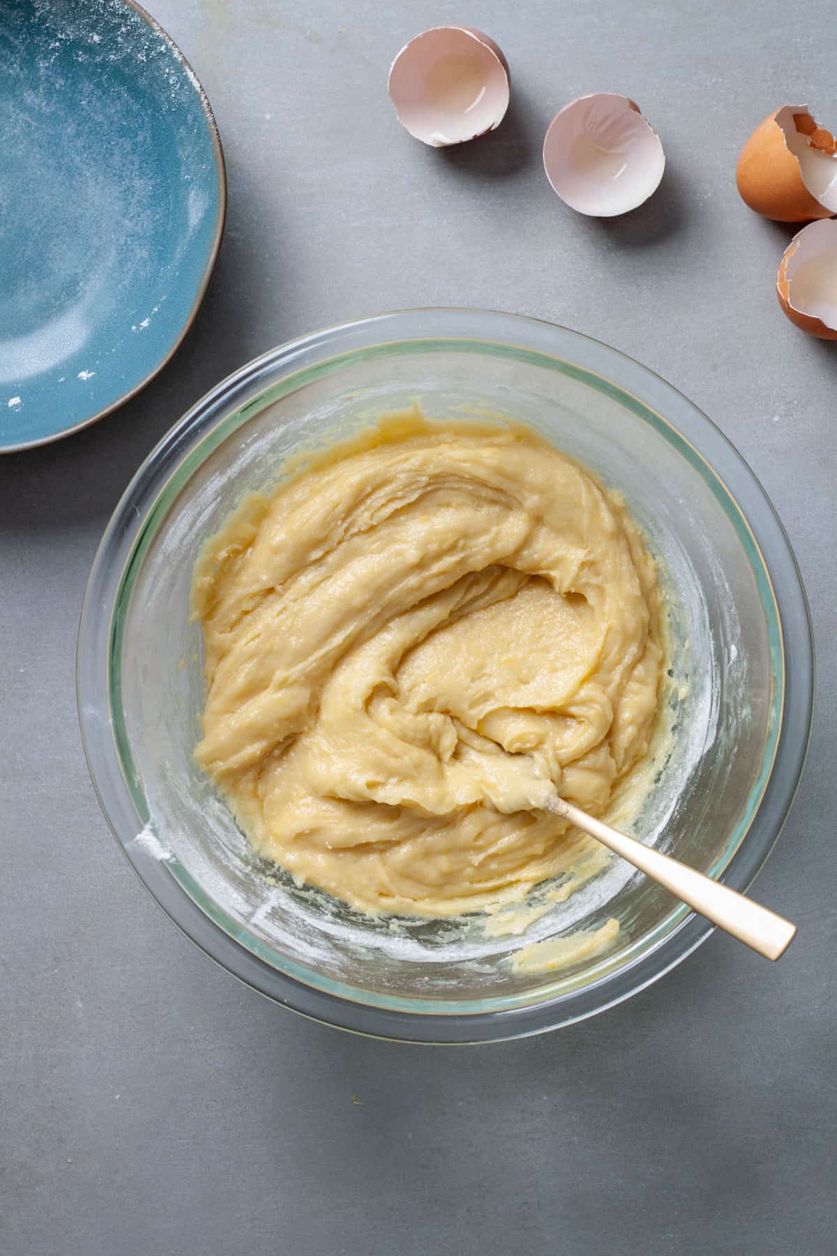 Lemon blondie batter in a glass bowl stirred together.