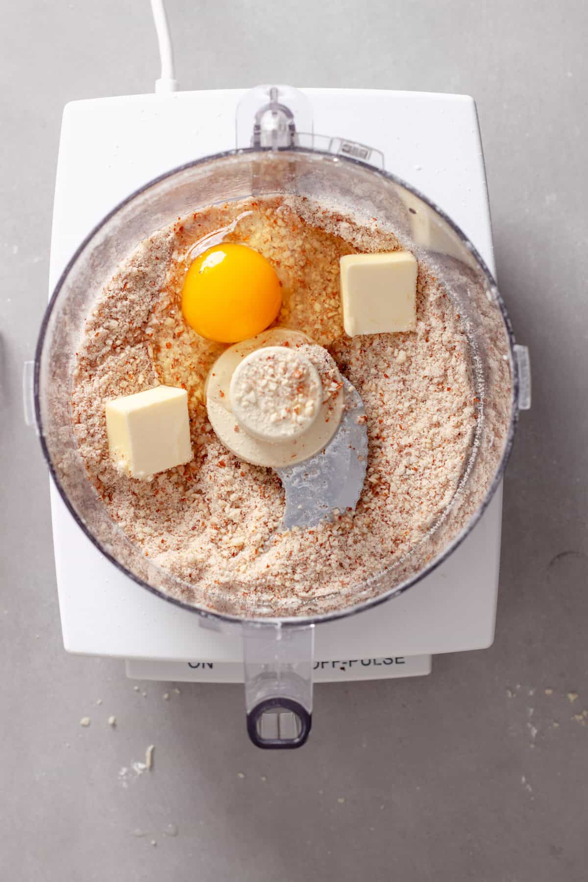 Ground almonds in a food processor with an egg and butter added.