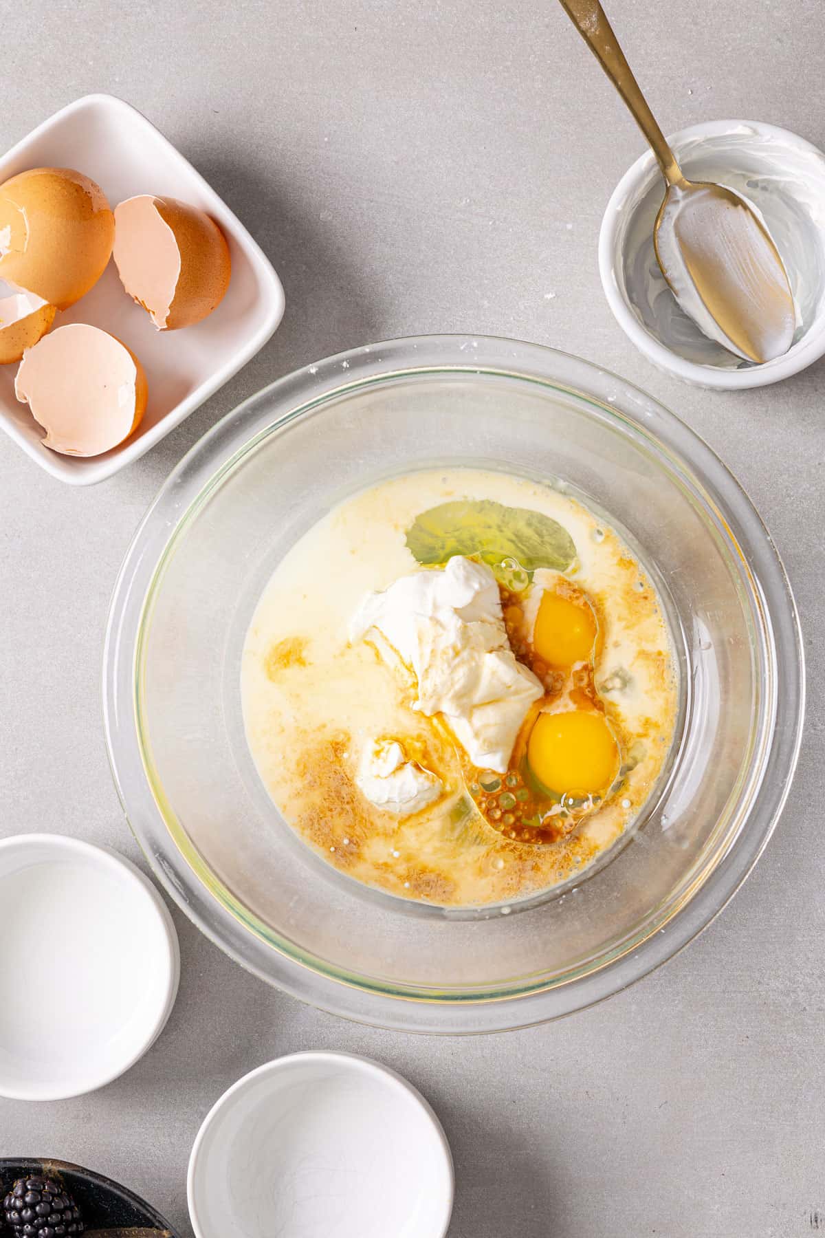 Wet ingredients for muffins in a glass mixing bowl.