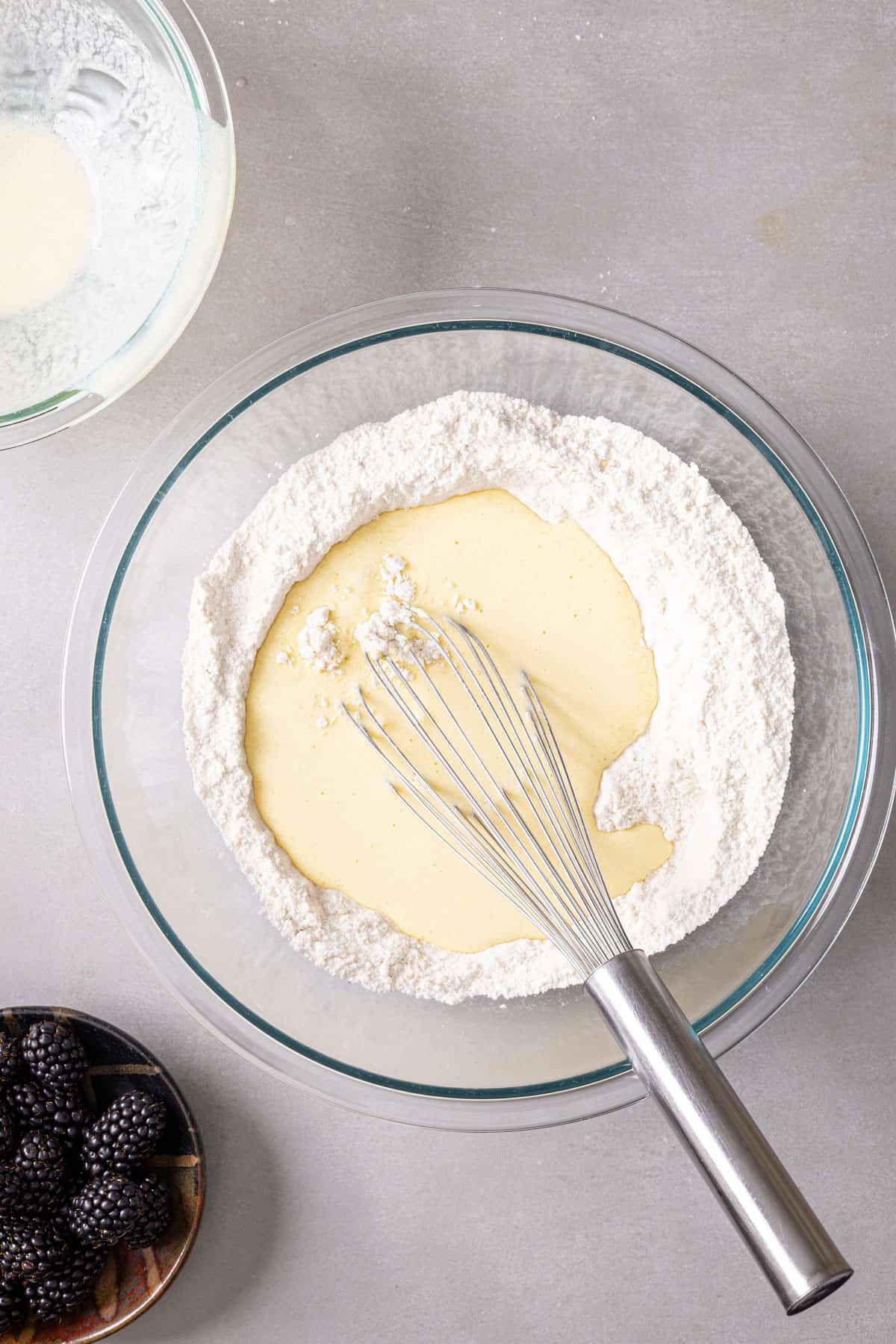 Wet ingredients added to dry ingredients for gluten free muffins.