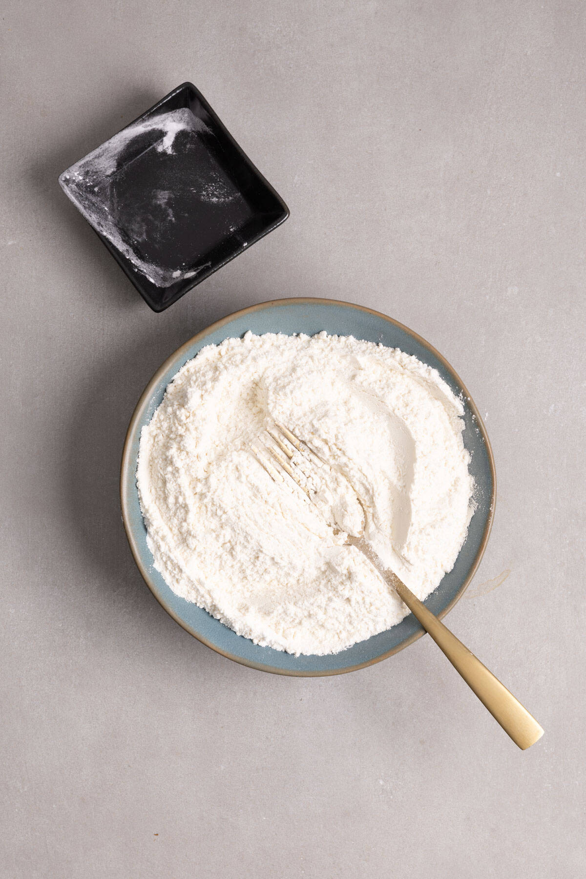 Dry ingredients for muffins in a medium green bowl.