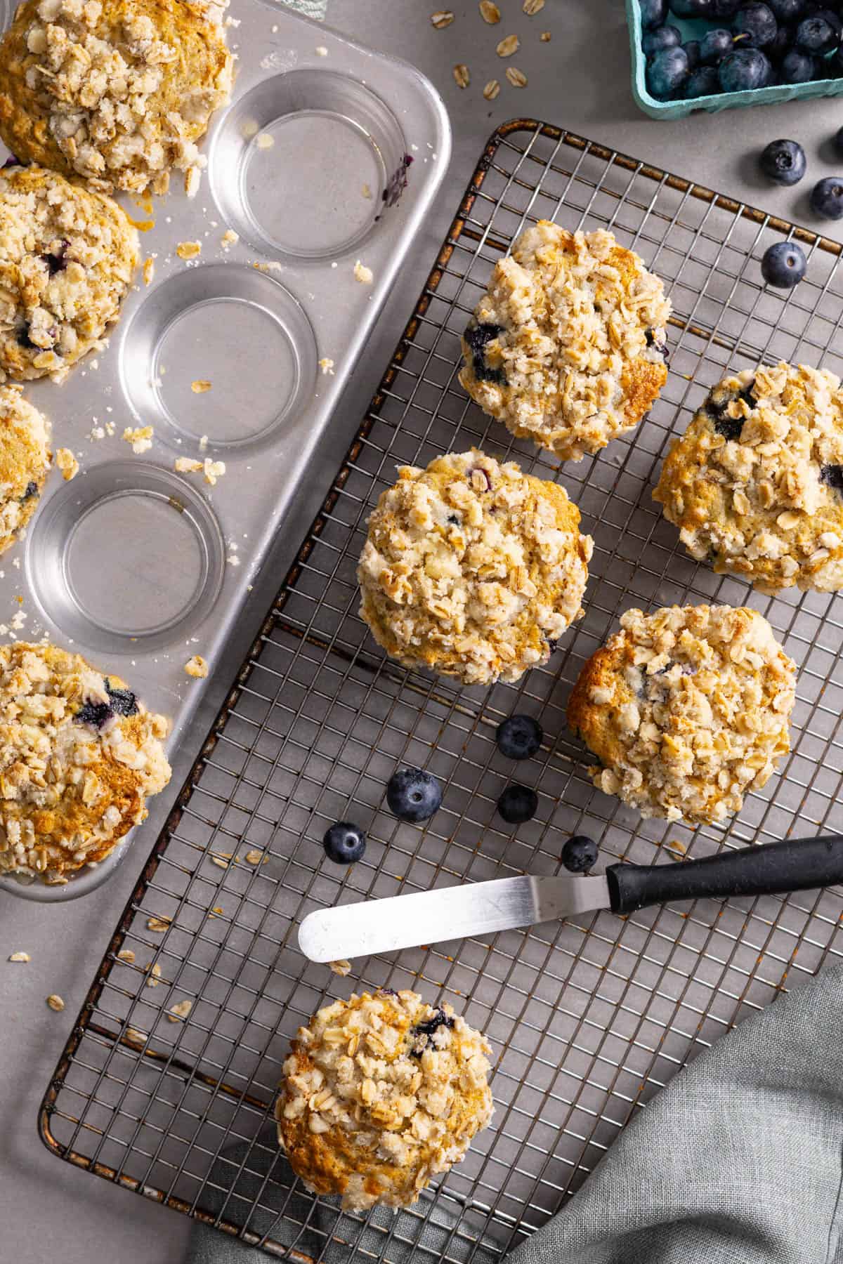 Blueberry lemon banana oat muffins cooling on a wire rack.