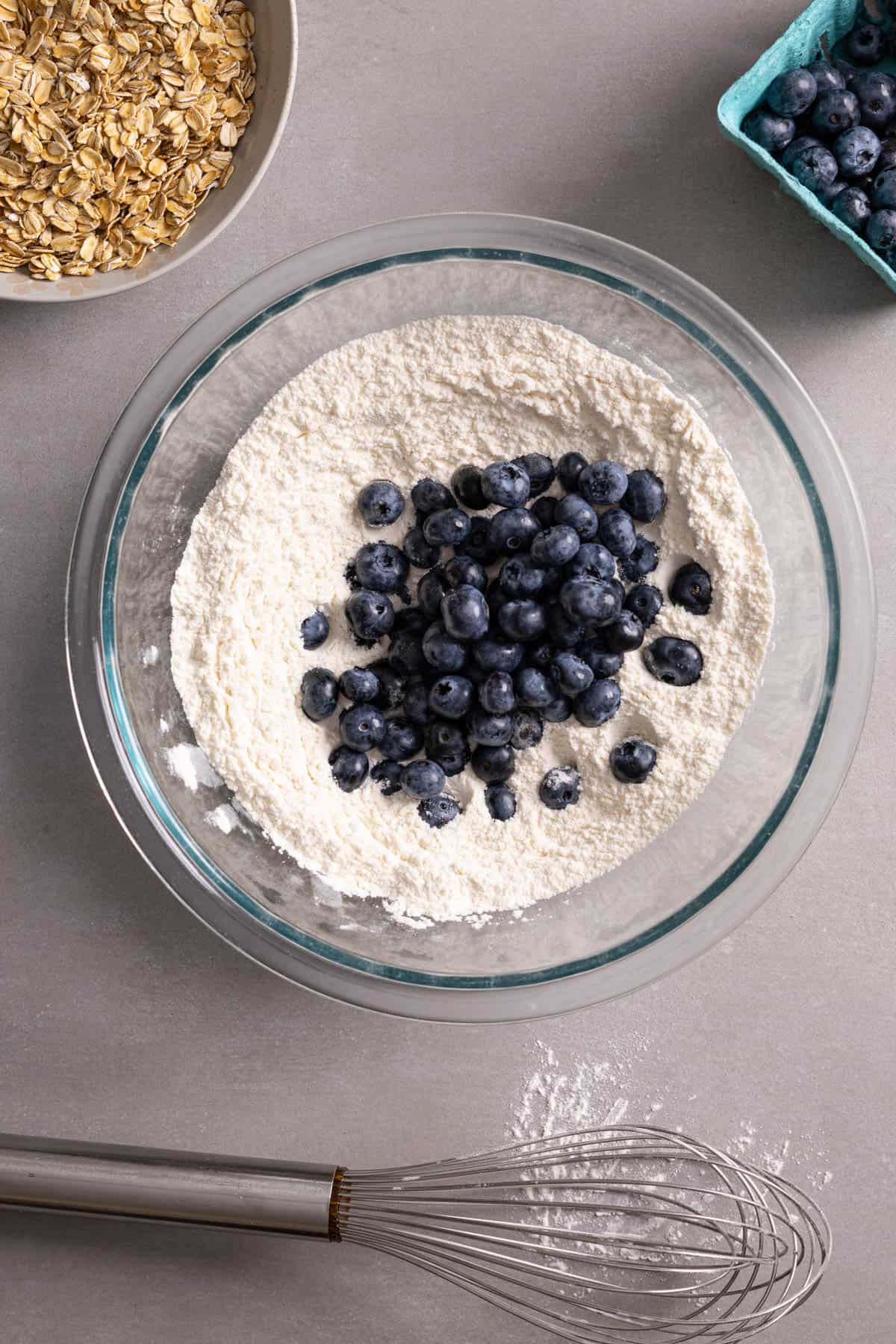 Fresh blueberries in a bowl with flour.