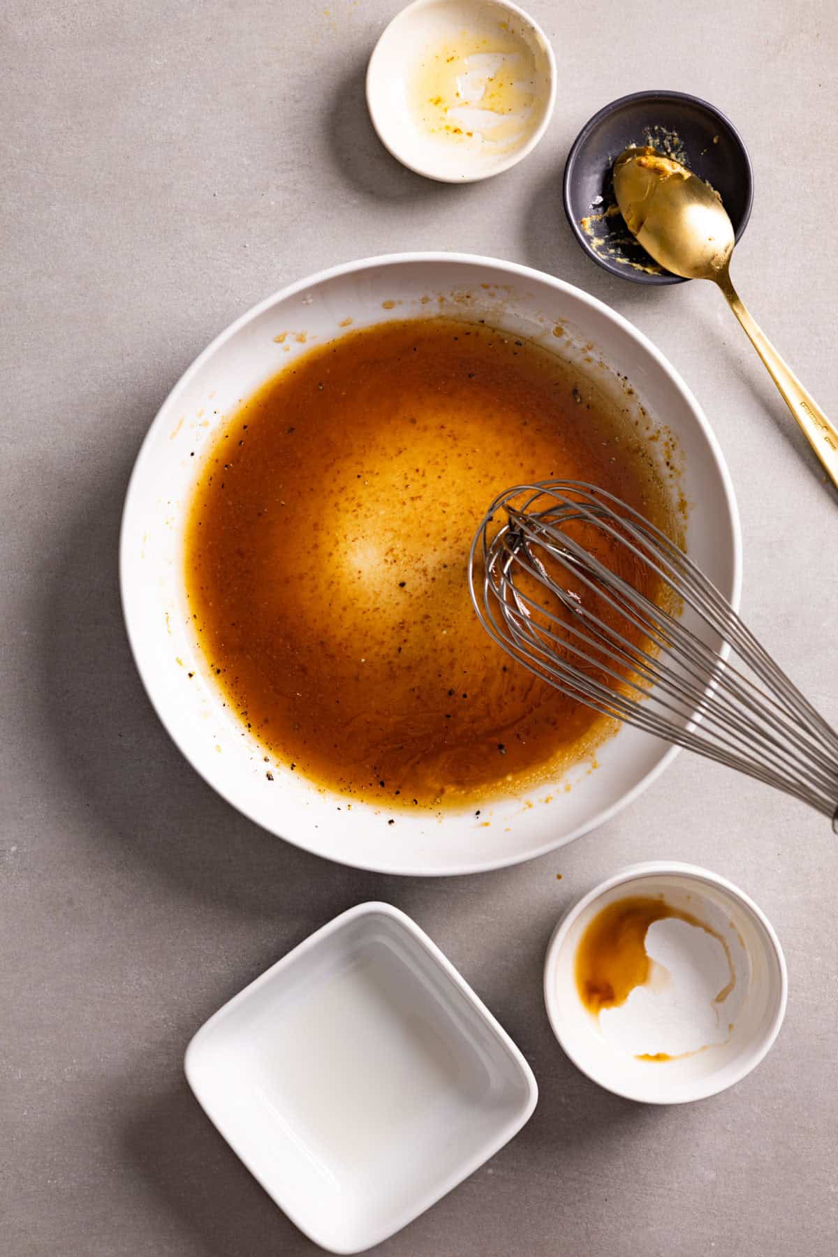 Oil drizzled into a bowl with balsamic vinaigrette.