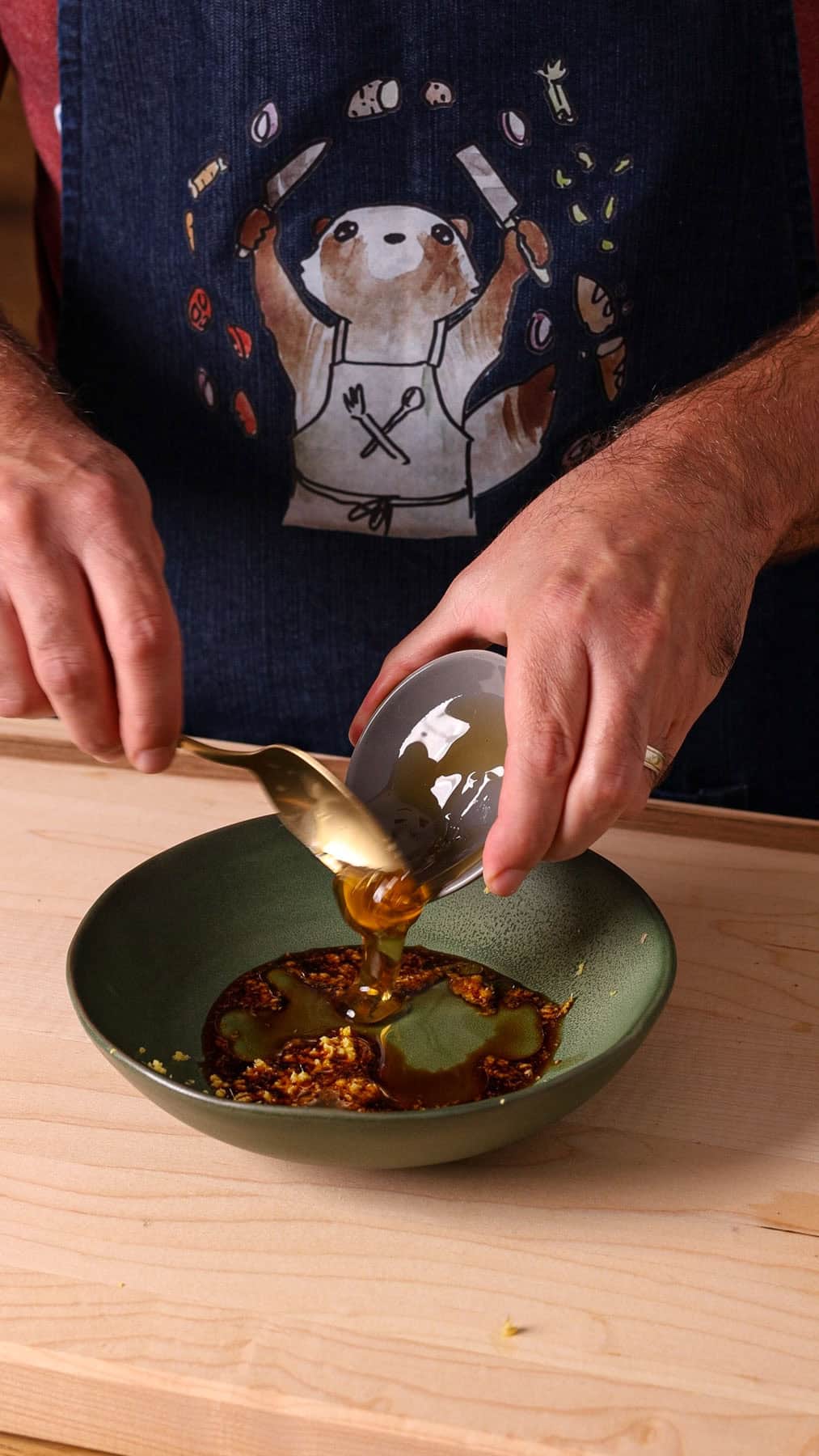 Ginger and soy sauce mixture getting stirred together in a small bowl.