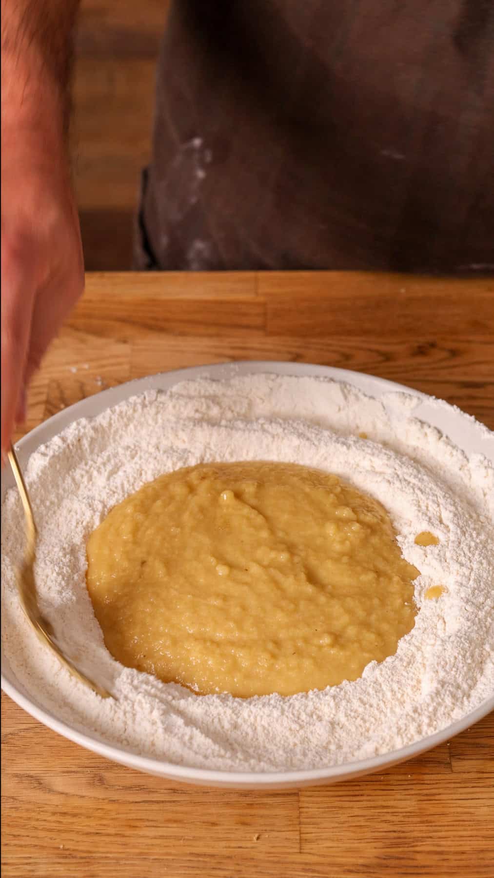 Applesauce cake getting mixed in a large bowl.