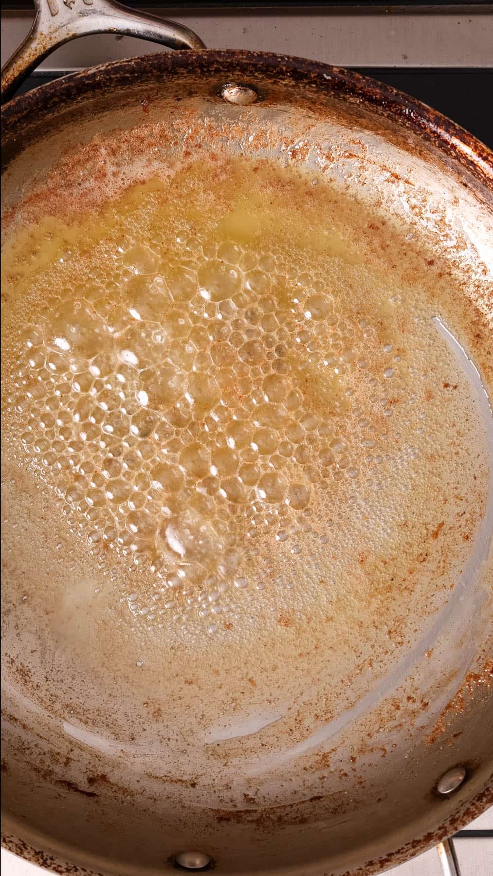 Butter melting in a large skillet.