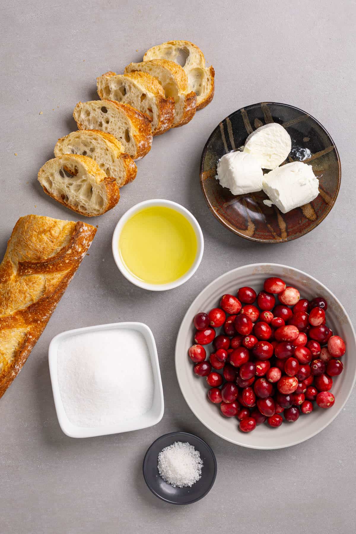 Ingredients for a goat cheese and cranberry crostini appetizer.