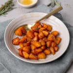 A close up of a bowl with air fryer honey roasted carrots.