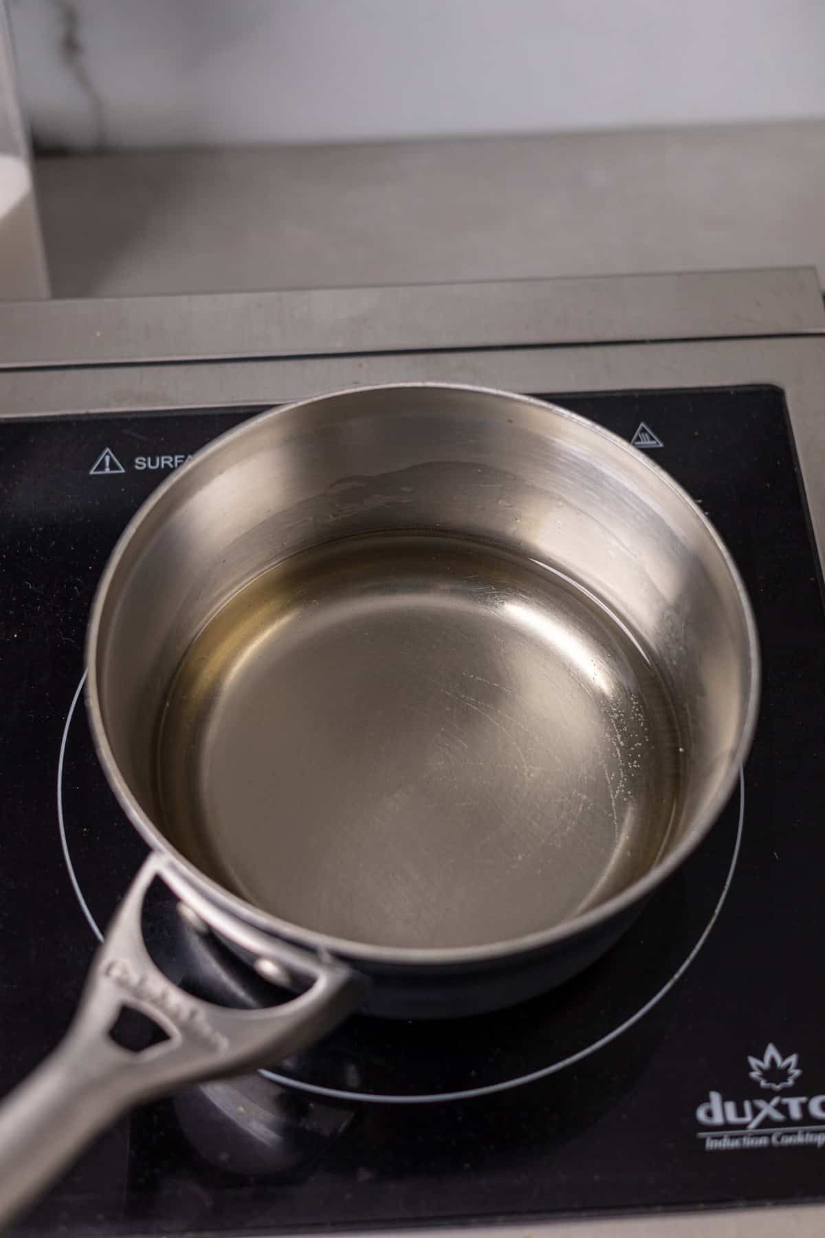 Simple syrup cooling in a small saucepan.