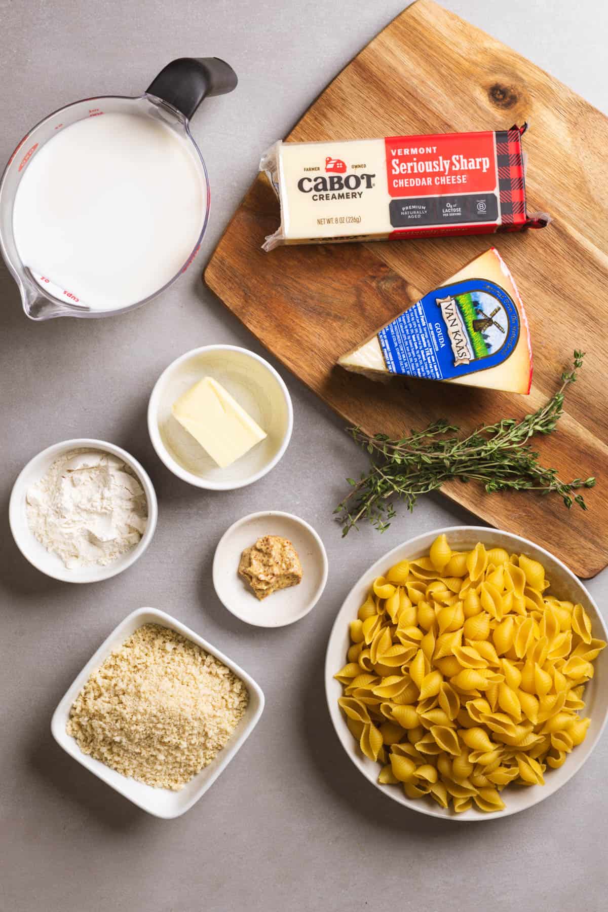 Ingredients for gouda mac and cheese on a gray table.