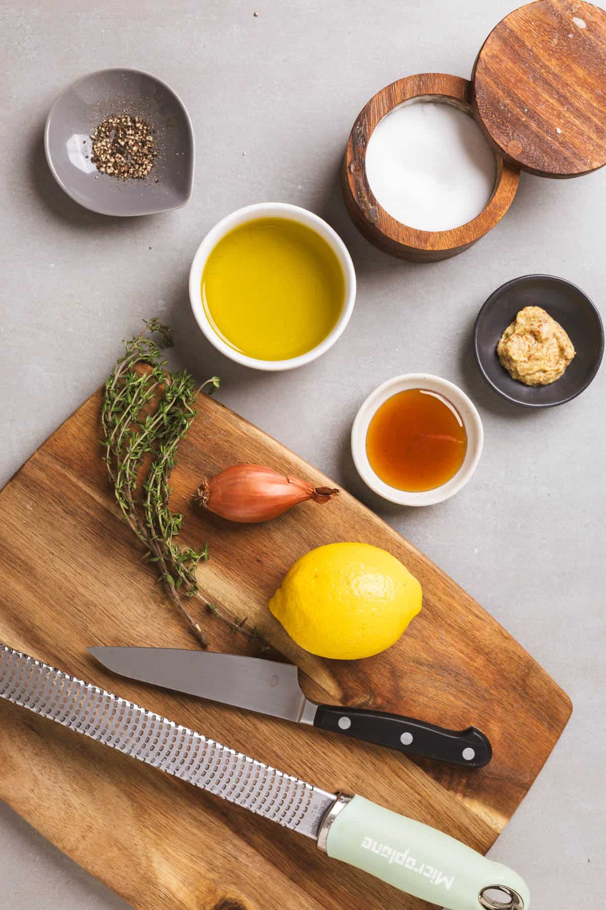 Ingredients for lemon thyme vinaigrette on a gray table. 