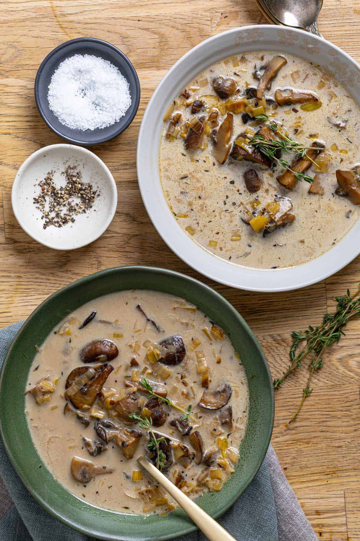 A close up of two servings of mushroom and leek soup.