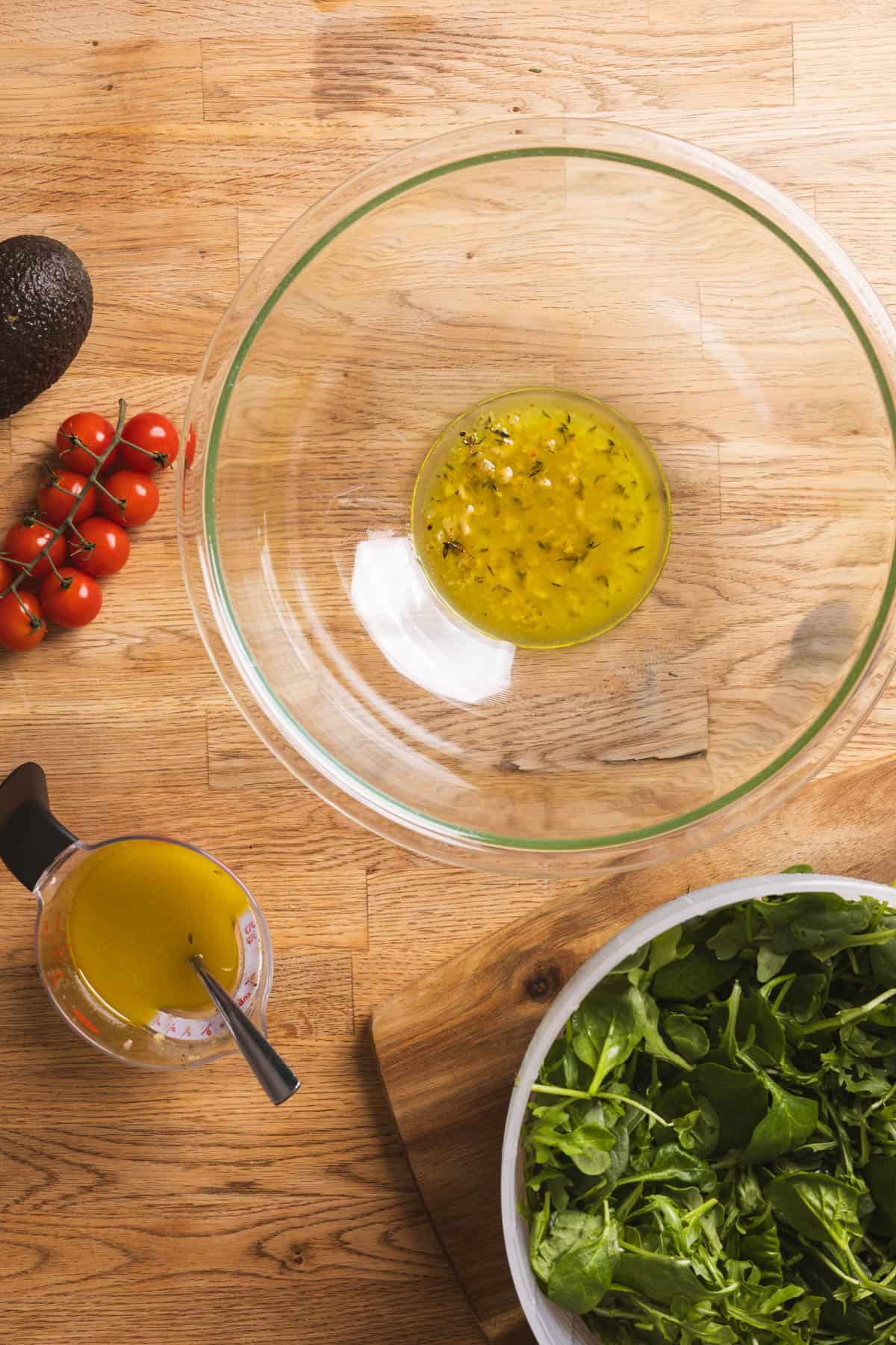 A lemon thyme vinaigrette in a large mixing bowl.