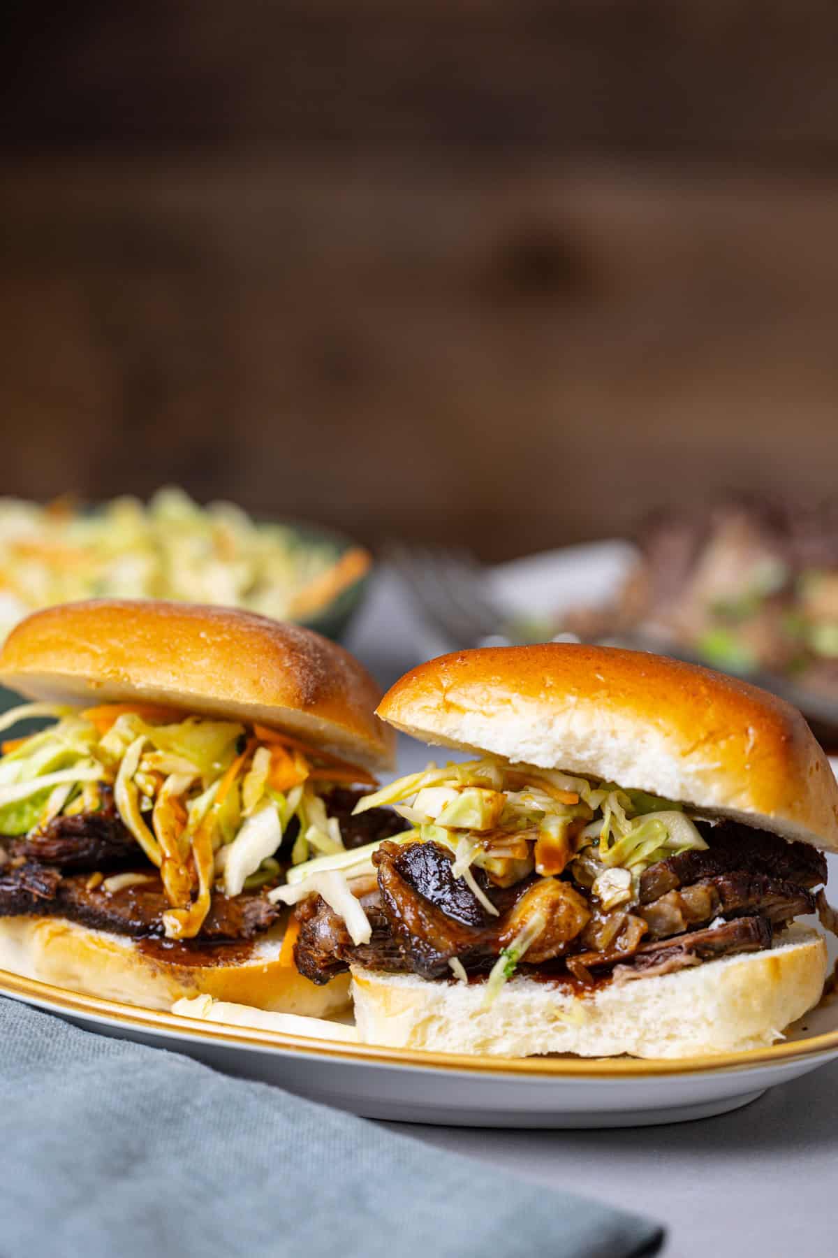 Two braised beef sliders topped with citrus slaw.