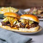 Two braised beef sliders topped with citrus slaw.