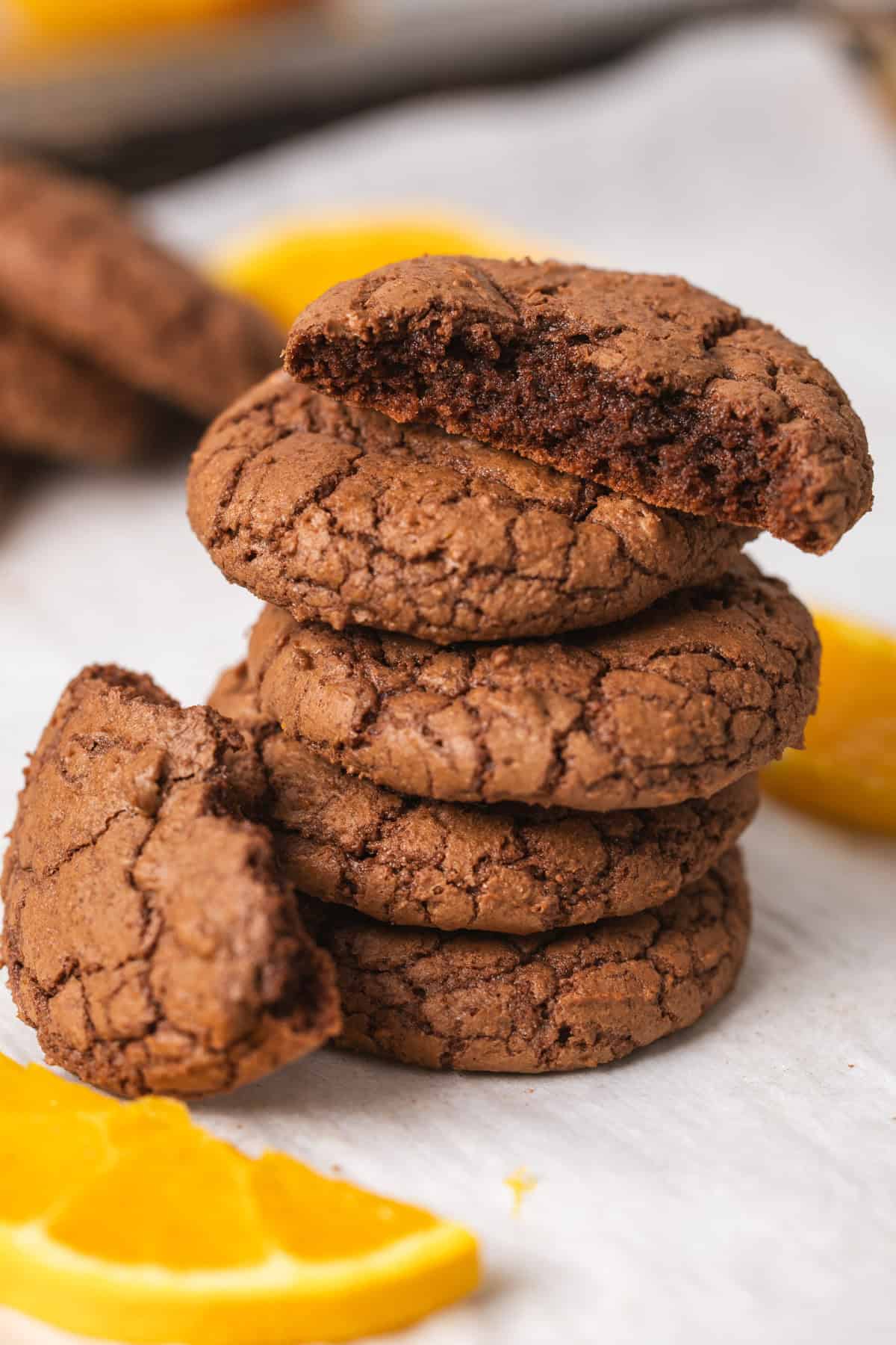 A close-up of a stack of chocolate and orange cookies.